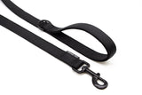the two ends of a black Landshark pro lead, showing the black latch on one end, and the sewn handle with integrated D-ring on the other.