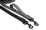 2 Leashes, black and gray, with black hardware on a white background. The gray leash features a sewn-on traffic handle.