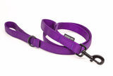 A purple nylon dog leash with black metal hardware, including a swivel snap hook and D-ring, shown on a clean white background. A small black fabric brand tag reading 'LANDSHARK SUPPLY' is visible on the strap.