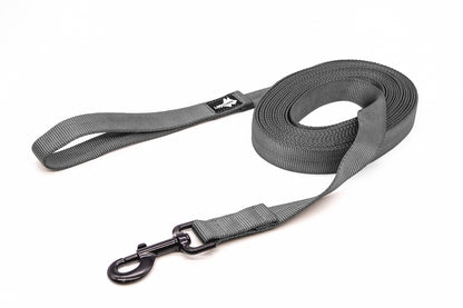 A gray extra long dog leash with a black latch, curled up on a white background.