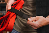 Person wrapping a dog leash with an elastic least wrap